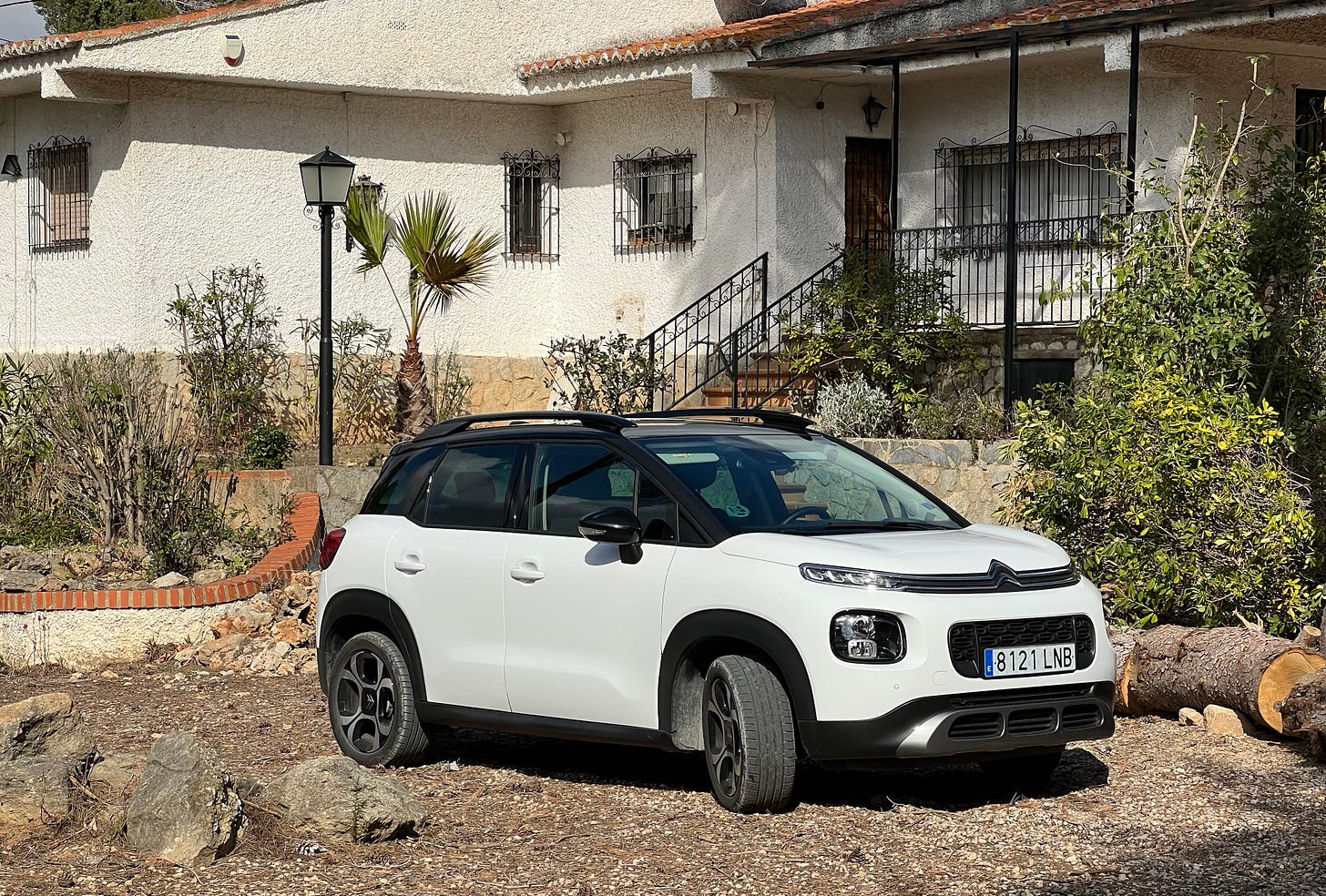 A white car parked on the dirt after a crazy drive through the Spanish mountains. You can’t hear the engine ticking as it cools down. A white car parked on the dirt after a crazy drive through the Spanish mountains. You can’t hear the engine ticking as it cools down.