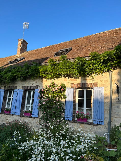 Snapshots of a small French village (Flagy) on a summer evening. A picnic basket, a lady making french fries, a beautiful small stone home, and musicians on stage