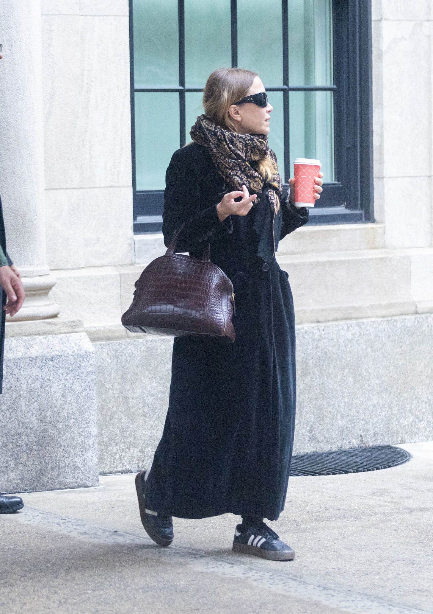 Image may contain Person Adult Accessories Bag Handbag Pedestrian Cup Disposable Cup Clothing and Scarf