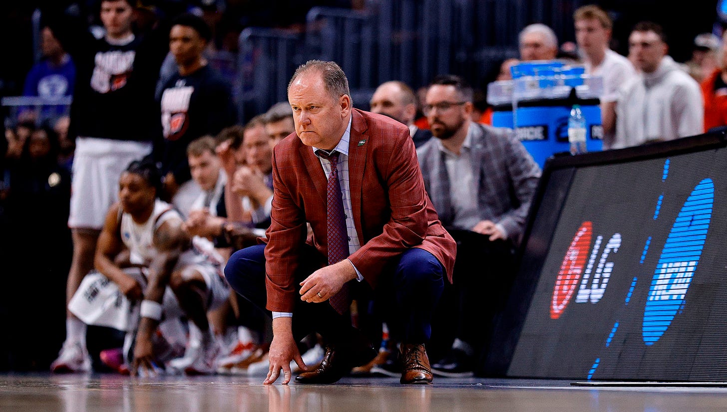 Wisconsin Badgers head coach Greg Gard kneels during the BYU game in the second round of the NCAA Tournament at Ball Arena
