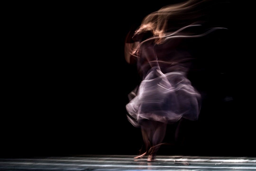 dancing woman on concrete pavement