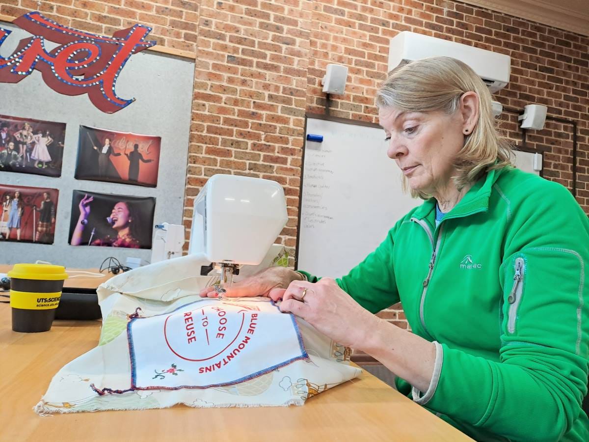 Alison sewing a label onto her boomerang bag. Alison sewing a label onto her boomerang bag.