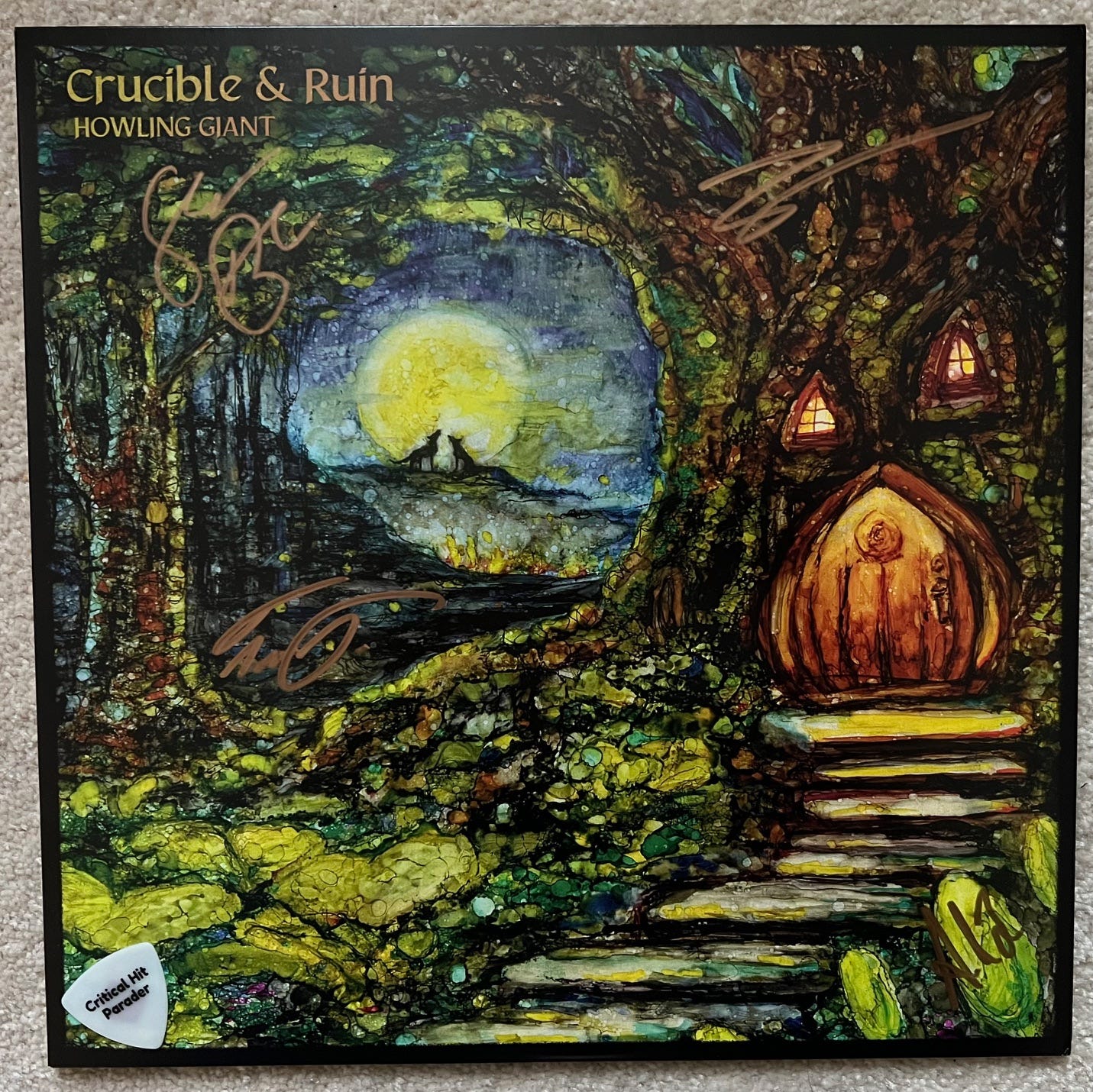 Album cover for "Crucible & Ruin" by Howling Giant. It features a painting by Susan M. Davies depicting forest home of some sort with a door and two windows built into a tree. Stone steps lead up to the door. Through a clearing between trees, two wolves are silhouetted in front of a full moon.