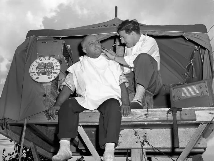 Charley Lupica gets a shave on top of his platform home. Charley Lupica gets a shave on top of his platform home.