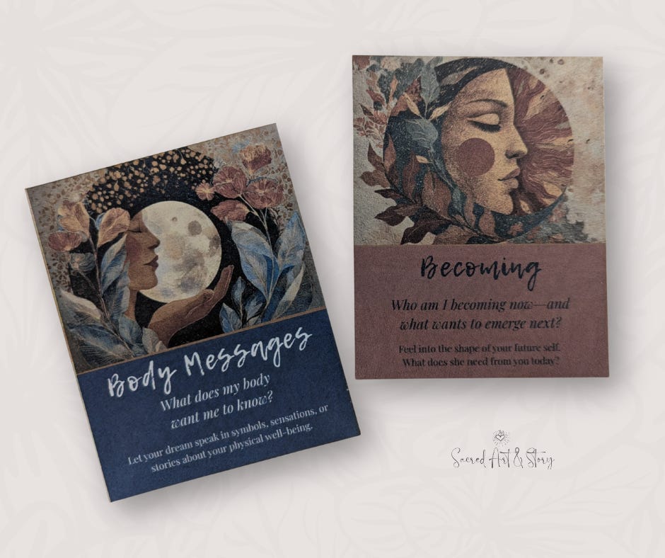 Two Dreamory oracle cards—Body Messages with a moon and floral design, and Becoming with a sun and feminine face motif.