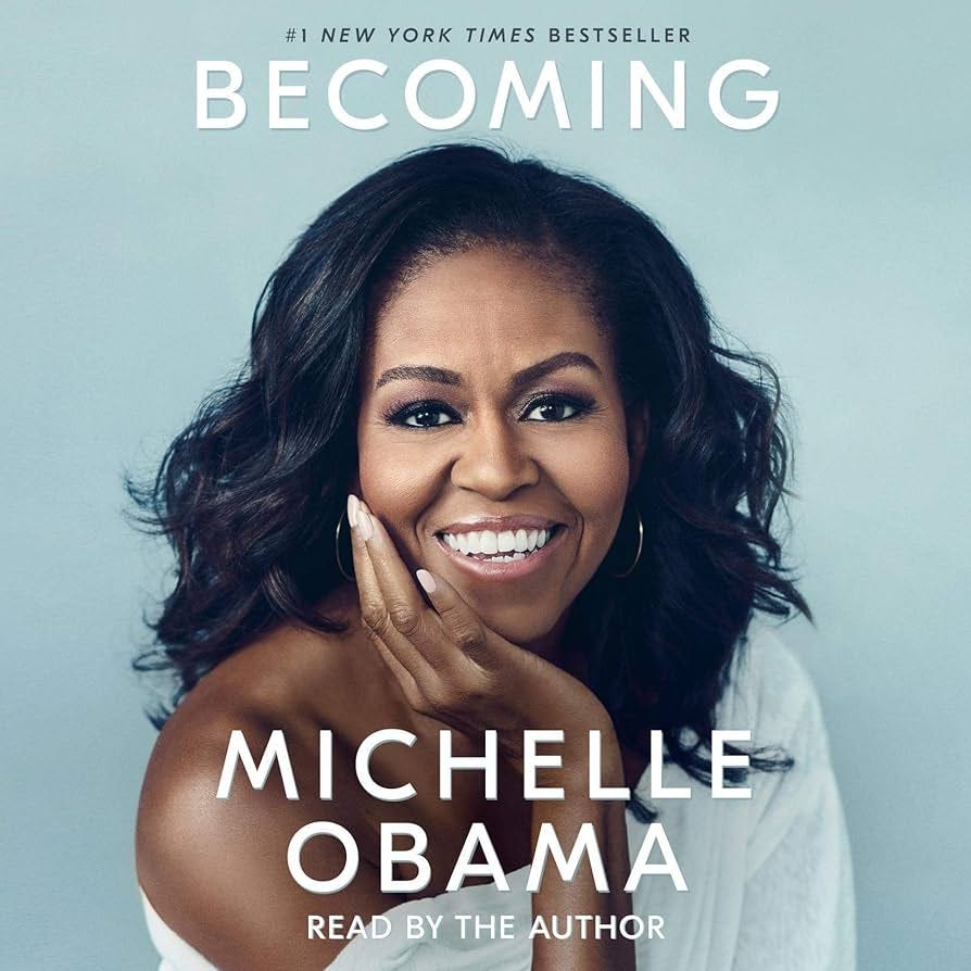Becoming Audiobook Cover with a portrait of Michelle Obama smiling at the camera in a white top.