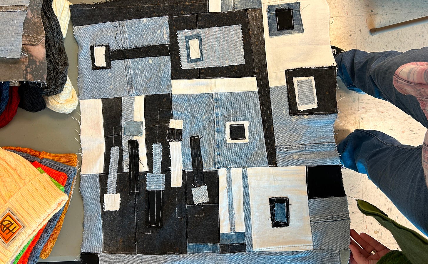 A photo of patchwork denim panel made by Ladianne. the patchwork is black, white, and blue denim, with top stitching. It's modern, but also scrappy! A photo of patchwork denim panel made by Ladianne. the patchwork is black, white, and blue denim, with top stitching. It's modern, but also scrappy!