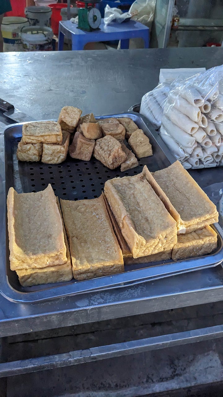 four market scenes: vendors, street produce, fried tofu, table of produce