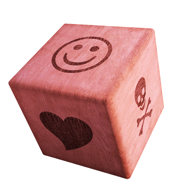A 6-sided dice showing 3 of its sides. On one side, a heart, on another, a skull and cross bones, and on the top side, a smiley face. The dice is red.