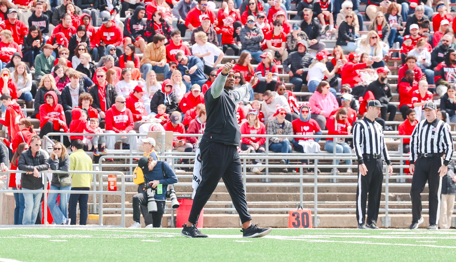 Wisconsin Badgers wide receivers coach Jordan Reid stands on the field during the Spring Showcase.