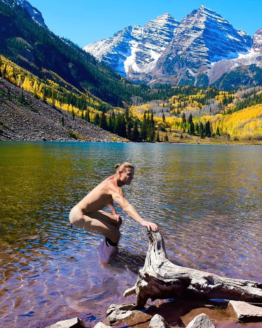 man defecating in lake