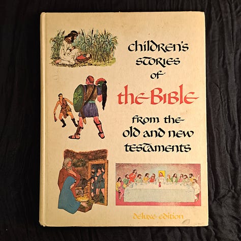 six childhood books set against wood or dark cloth