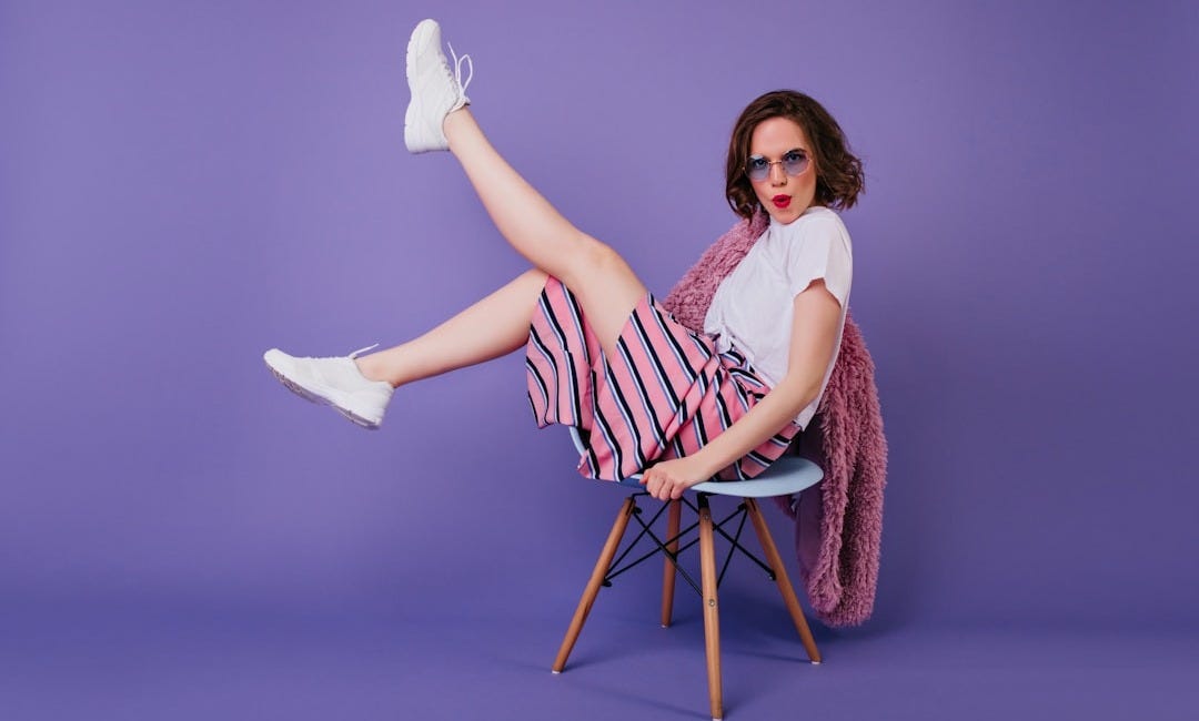 a woman sitting on a chair with her legs crossed