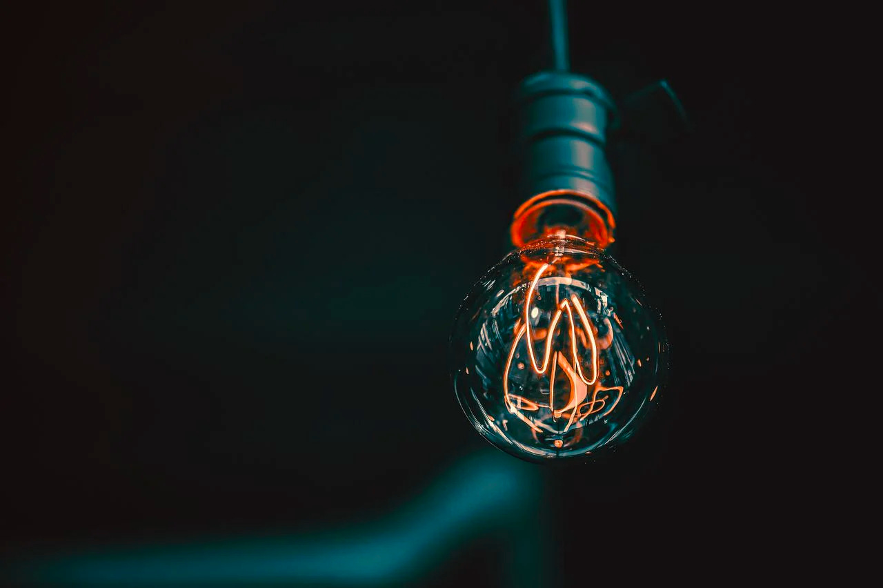 dimly glowing bulb on dark background