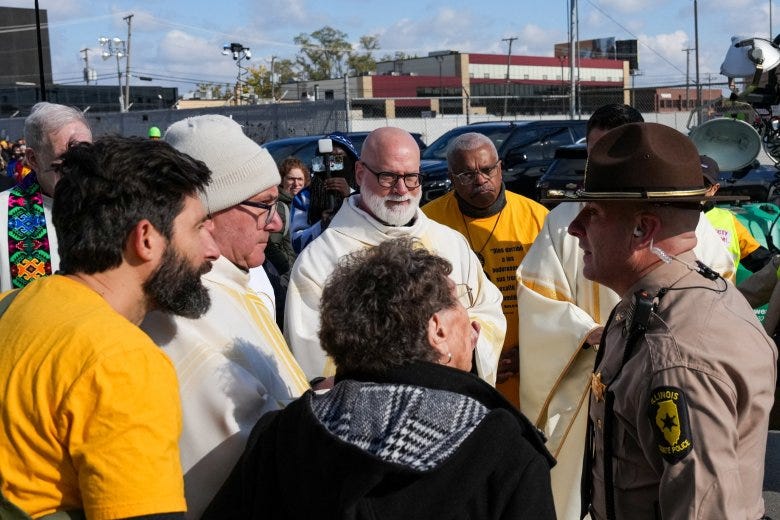 Clergymen talk with law enforcement officers preventing religious leaders from entering the ICE facility in Broadview, Ill., to offer Communion to immigrants detained inside during an outdoor Mass in Broadview on the outskirts of Chicago Nov. 1, 2025.