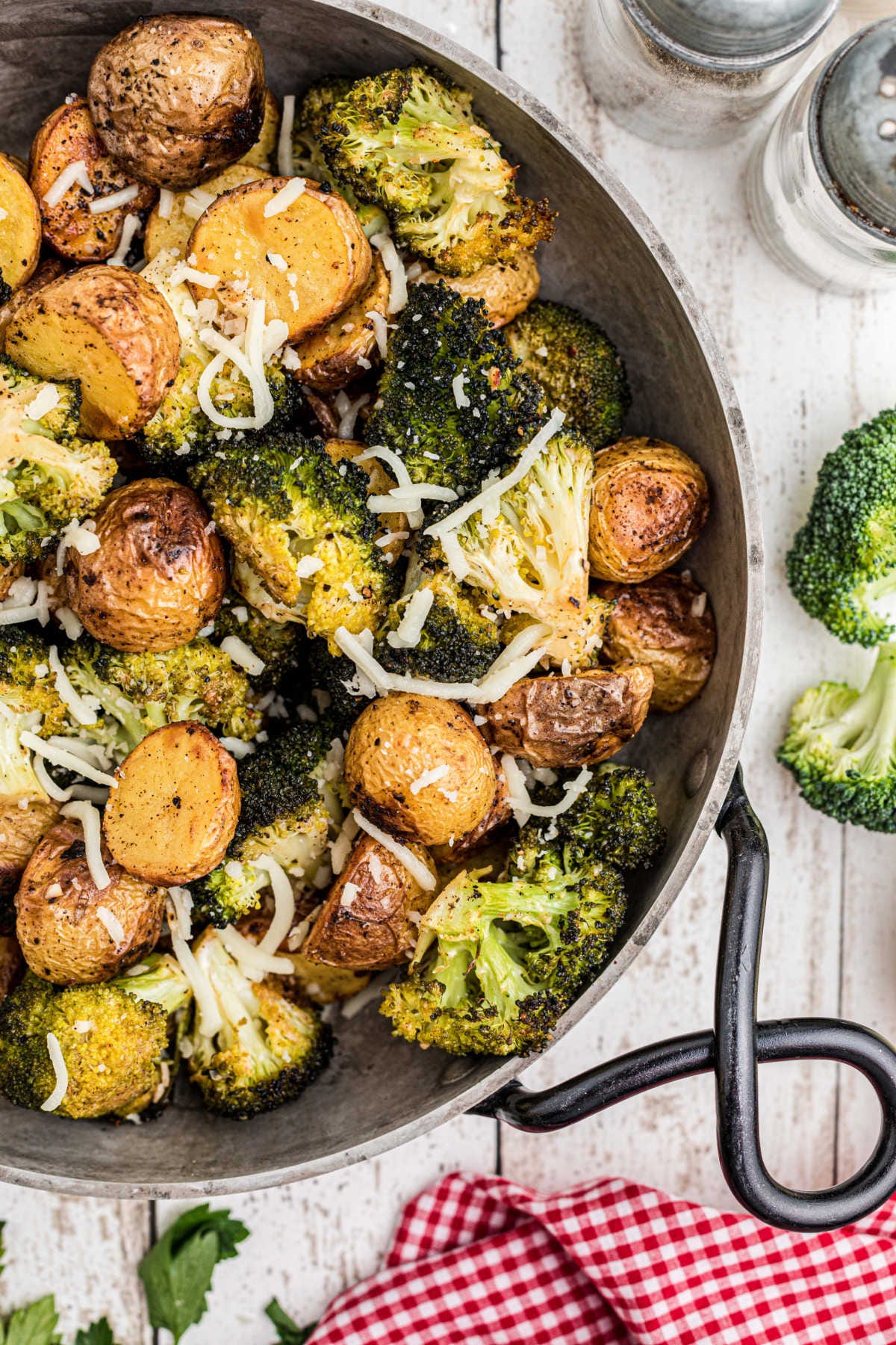 Overhead close up shot of a pan of roasted potatoes and broccoli. Overhead close up shot of a pan of roasted potatoes and broccoli.