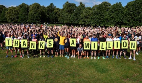 A large group of runners holding a sign saying Thanks a Million A large group of runners holding a sign saying Thanks a Million