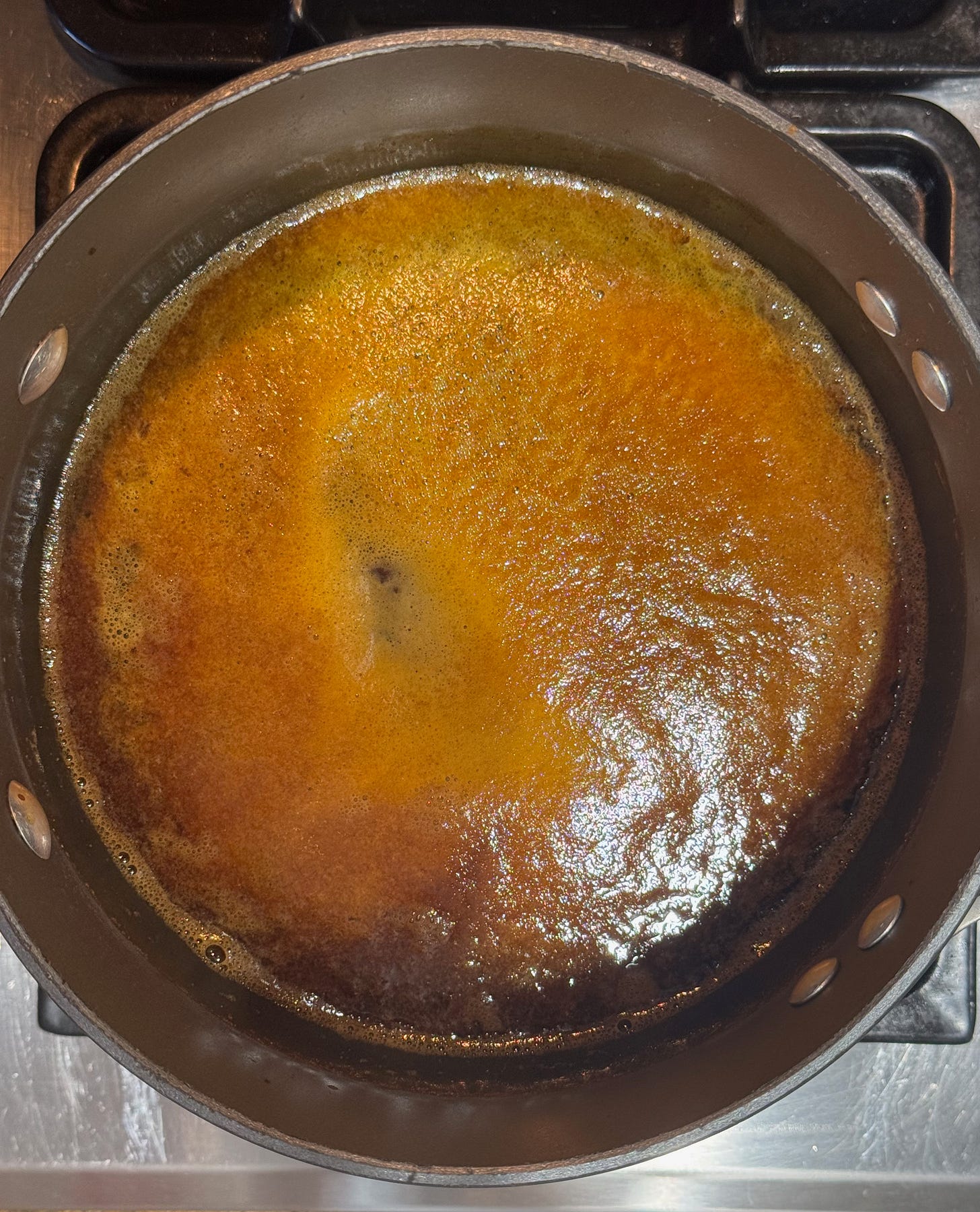  Pork marinade reducing to amber gold on the stove — the finishing sauce behind Doug's grilled tenderloin at The Dinner Bell Hearth