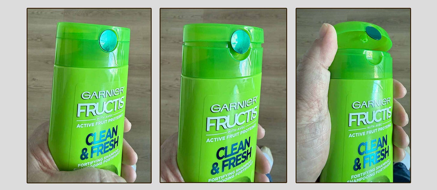 Three color photos of the author holding a shampoo bottle. The lid is smooth, hard plastic, and hinges. A round blue depression is part of the upper part of the lid, ready for your thumb. The three photos show the lid closed, ajar, and somewhat open.
