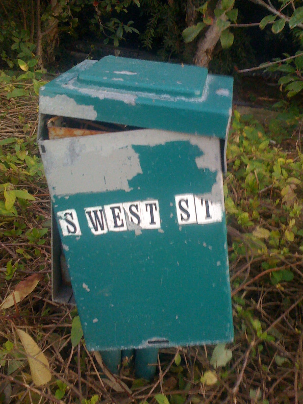 Photo of an electrical junction box or similar. The box is dilapidated and broken.
