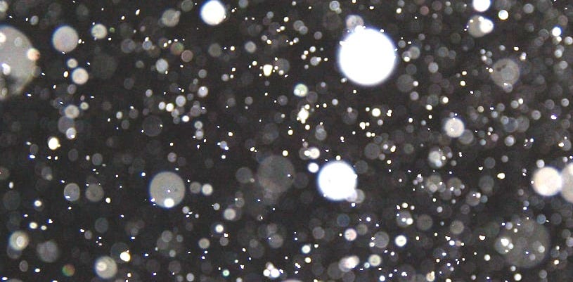 a black and white photo of snow flakes