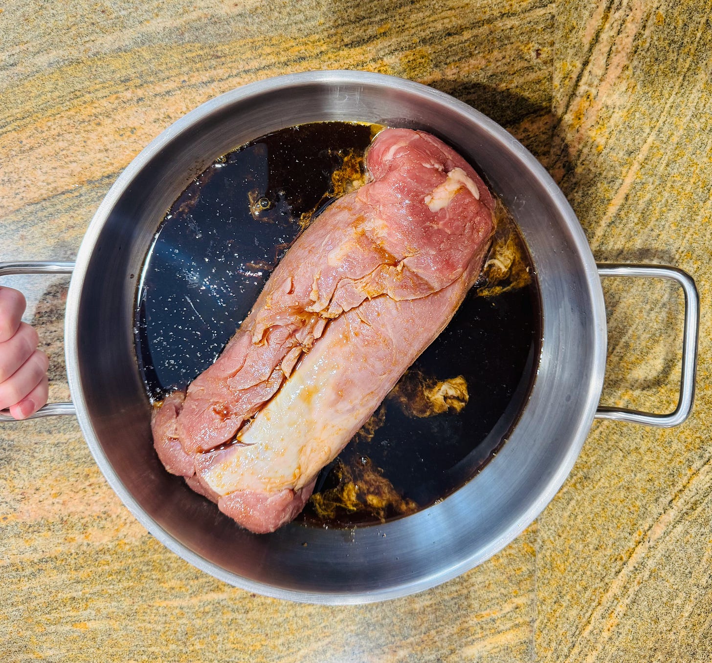 Pork tenderloin resting in dark soy and citrus marinade — the foundation of Doug's Easter recipe at The Dinner Bell Hearth
