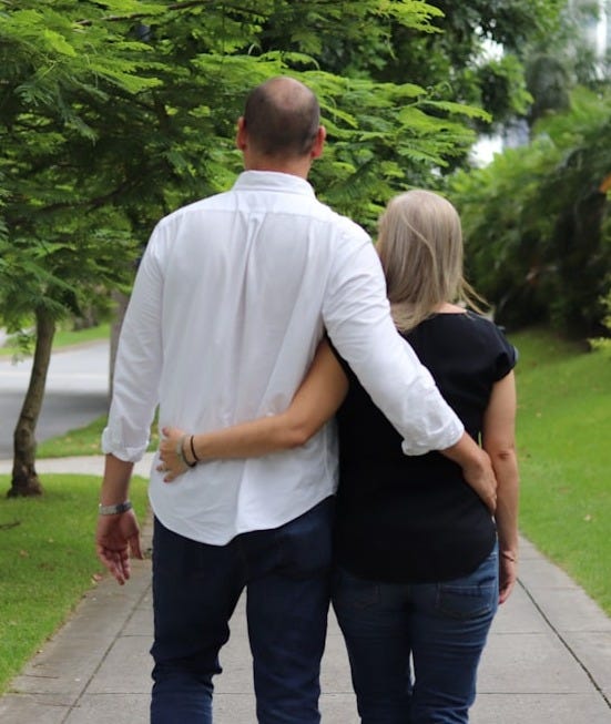 a man and a woman walking down a sidewalk a man and a woman walking down a sidewalk