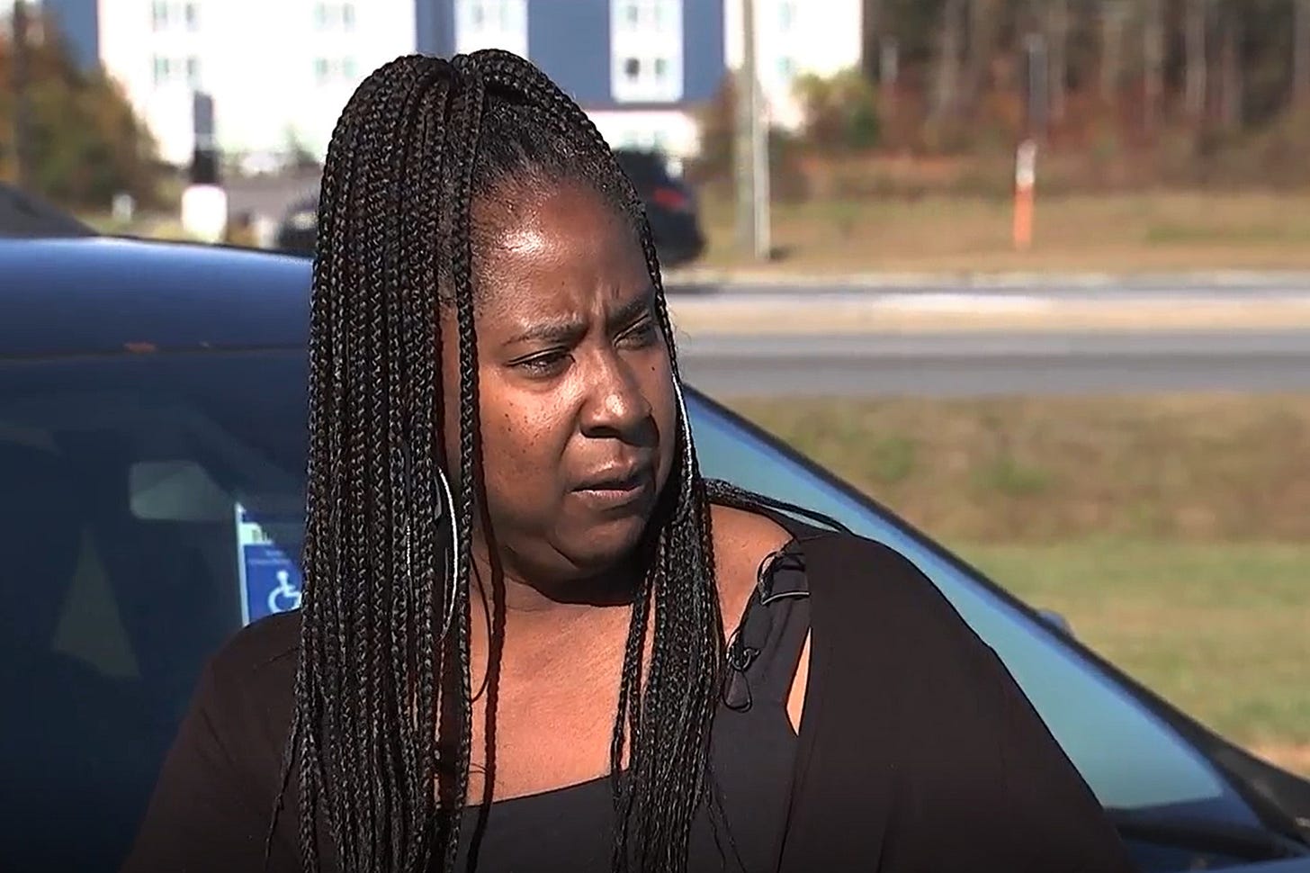 A photo of Denise Woods by her car outside. A photo of Denise Woods by her car outside.