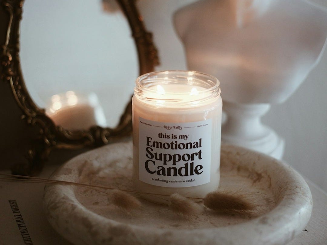 a candle sitting on top of a table next to a mirror