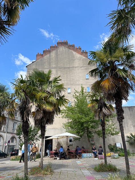 Shopping arcade Passage Pommeraye, lunch table at Les Chants d'Avril, office building at Quartier Madeleine, giant croissant at Boulangerie Fourmi, and famous independent bookshop Coiffard and its sculpture installation above