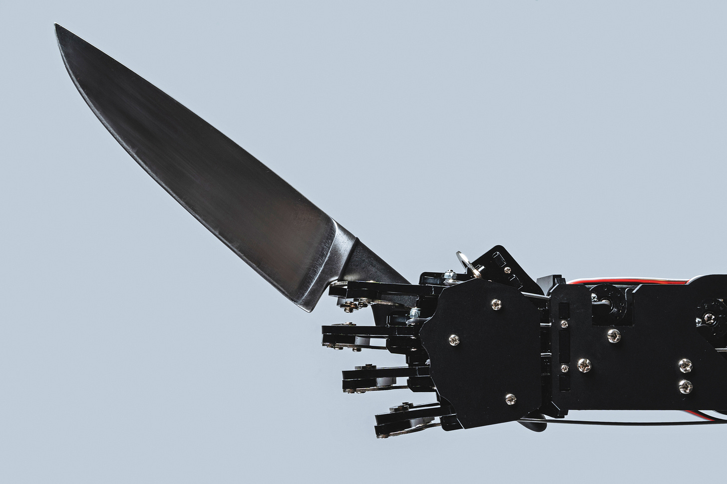 Robot hand holding scary slasher killer knife Robot hand holding scary slasher killer knife