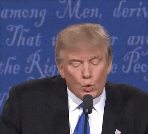 donald trump blowing a kiss at a microphone in front of a blue background that says among men donald trump blowing a kiss at a microphone in front of a blue background that says among men