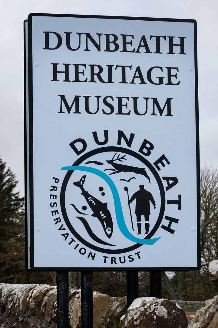 Dunbeath Heritage Museum sign and a stained glass window suggestive of river life and Pictish symbols © Felicity Martin