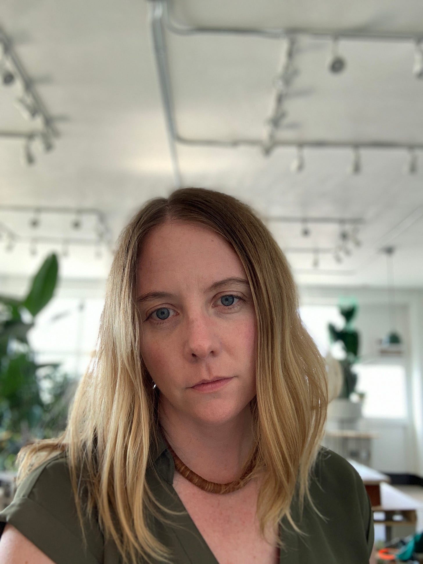 tired woman staring off in the distance with half-built retail plant shop in the background tired woman staring off in the distance with half-built retail plant shop in the background