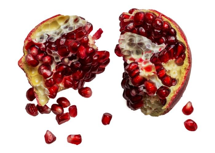 This may contain: the pomegranate is cut in half and placed on top of each other