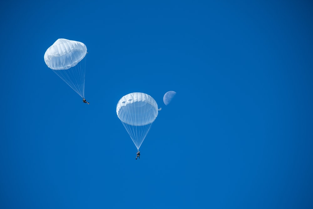 two white parachutes two white parachutes
