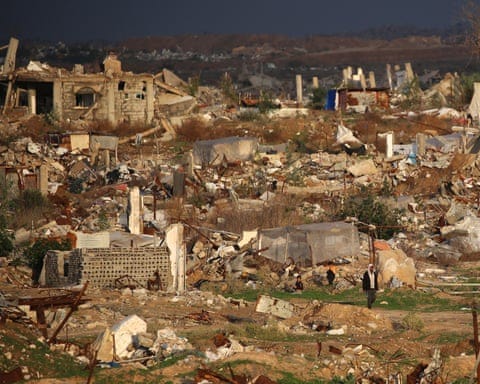 Rubble on a rolling, green and brown landscape.