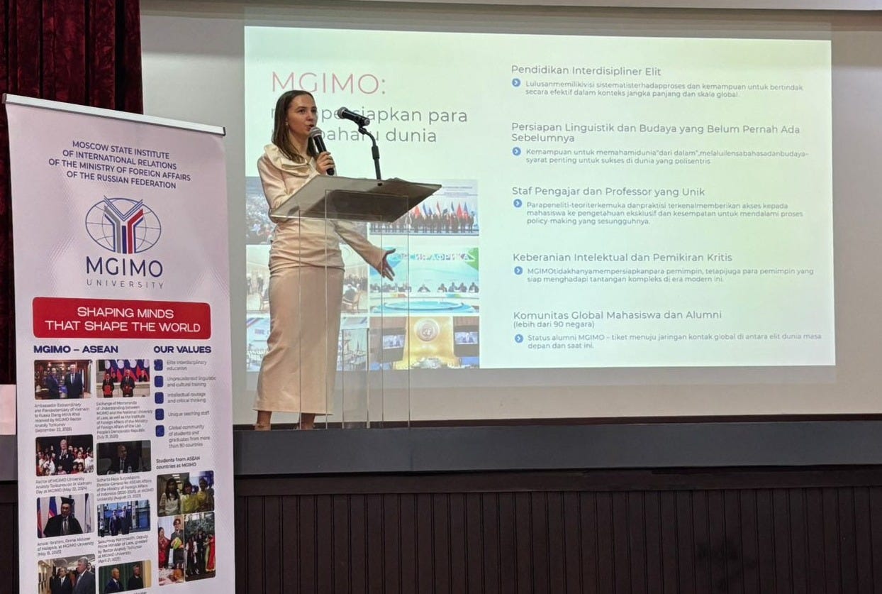 A female representative of MGIMO delivered a speech at a podium on a stage with a backdrop written in Indonesian language.