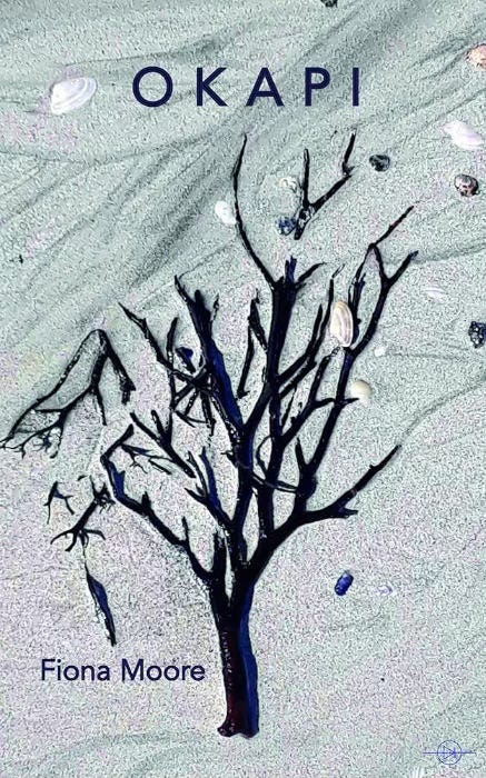 Swirling blue. tinted background looks a bit like sand. There is a flat tree shape possibly made of seaweed and some random shells are lying on the aforementioned grey-blue swirly sand stuff.