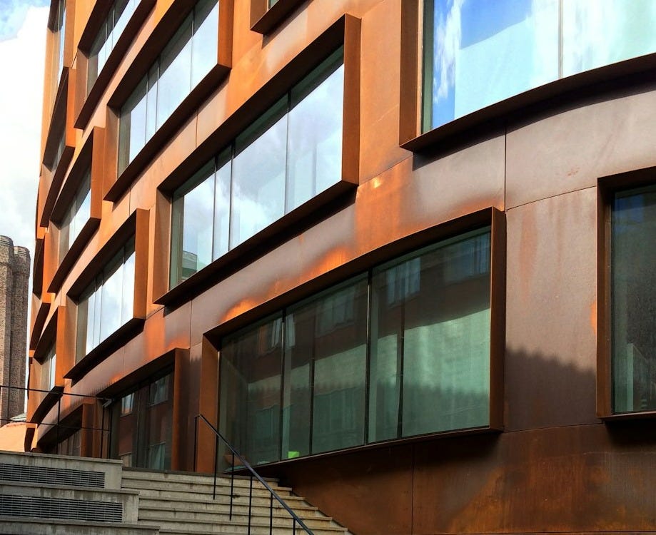 brown concrete staircase with stainless steel railings