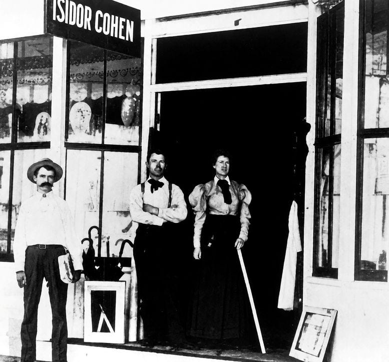 Figure 1: Isidor and Ida Cohen (right), standing in front of Cohen’s store on Twelfth Street, today’s Flagler Street. Found in the 1904 City Directory. Figure 1: Isidor and Ida Cohen (right), standing in front of Cohen’s store on Twelfth Street, today’s Flagler Street. Found in the 1904 City Directory.