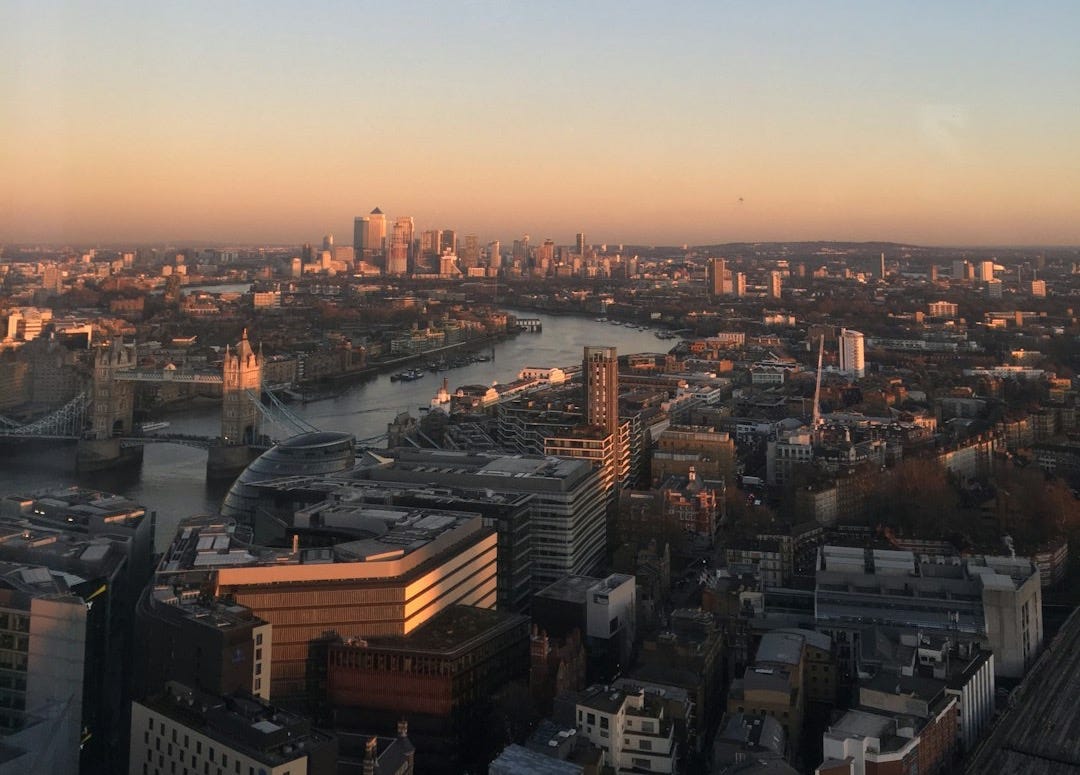 moon seen on blue and orange sunset sky over the city moon seen on blue and orange sunset sky over the city