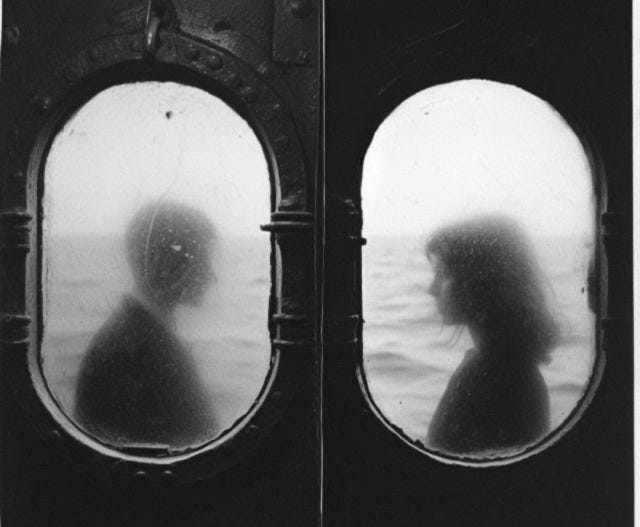 This may contain: two people are seen through the portholes of a ship's door as they look out into the water