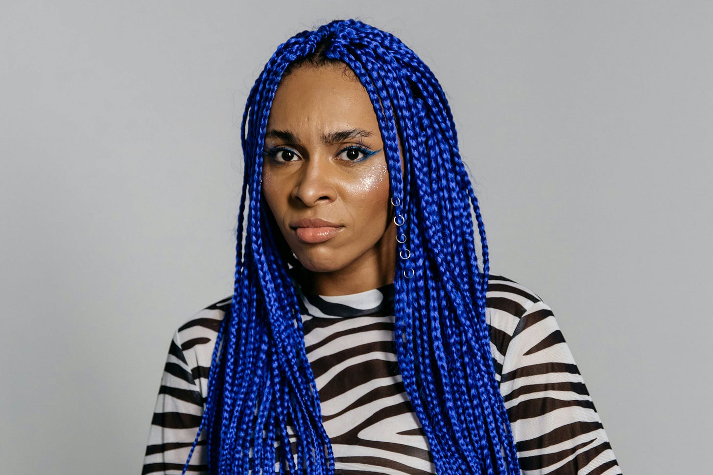 Woman with long blue braids who is having spiritual doubts Woman with long blue braids who is having spiritual doubts