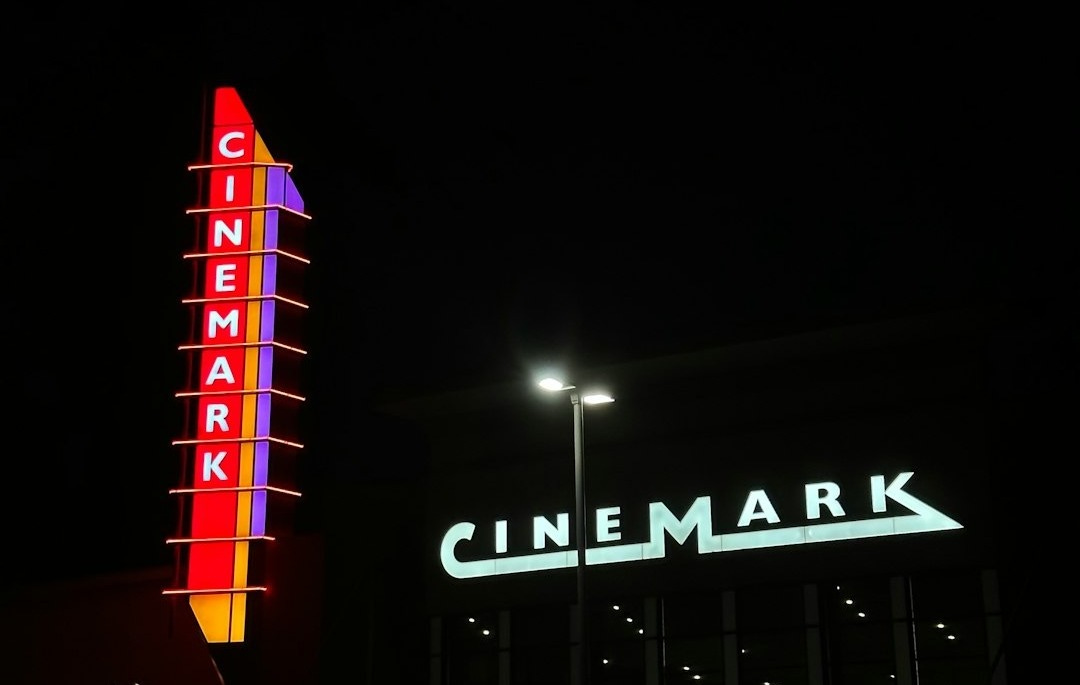 a large neon sign is lit up in the dark