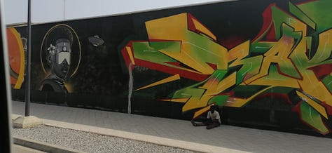 Pictures of the artwork on sale at the Marche des Arts de Cotonou, the Amazone statue, the Benin Congress building, and the second largest graffiti wall in the world