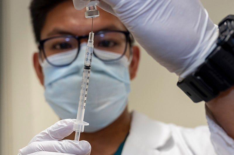 A medic prepares a dose of the Covid-19 vaccine.