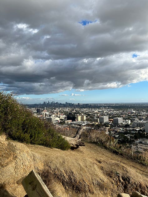 the map of the trails, views from the trails, including the locks on a fence line and the paved path down, and Hannah smiling with the Hollywood sign - pretty far behind her