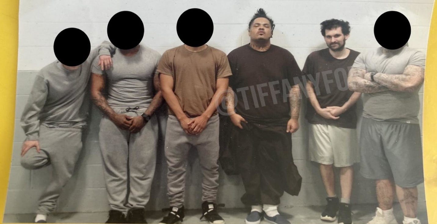 A group of men standing in a row

Description automatically generated