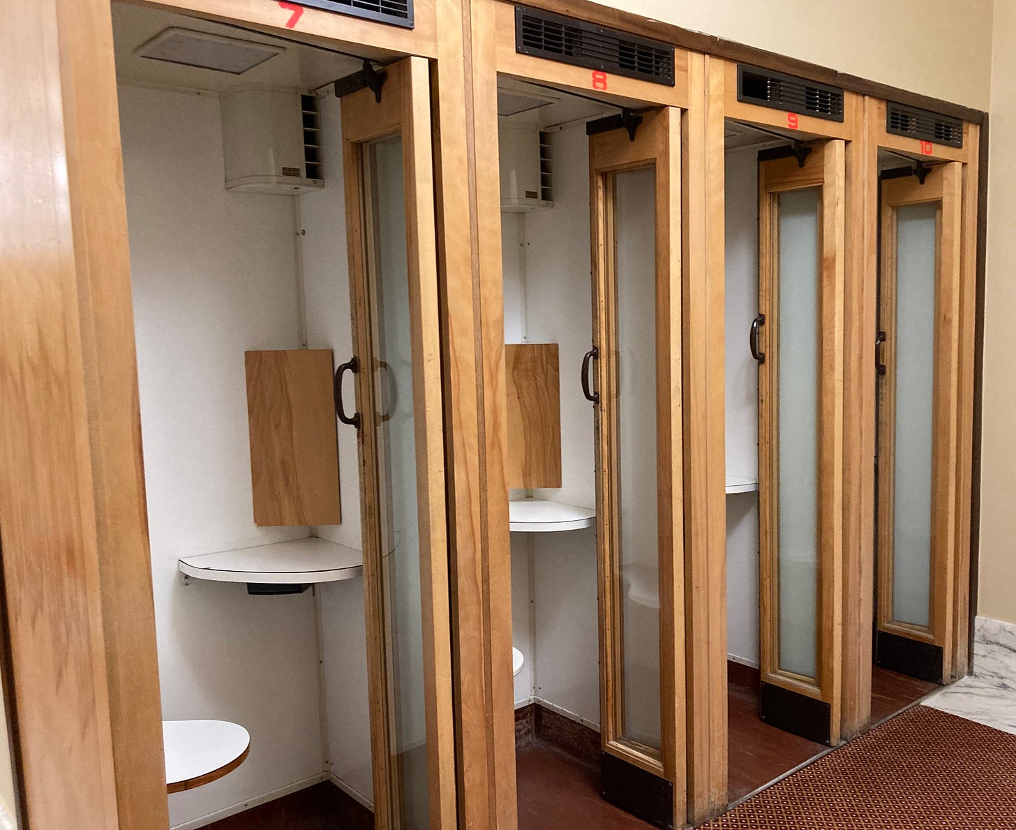 Four old phone booths with phones removed